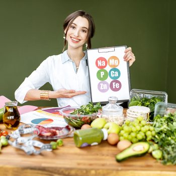 dietitian-with-vitamin-sheme-at-the-table-full-of-resize.jpg